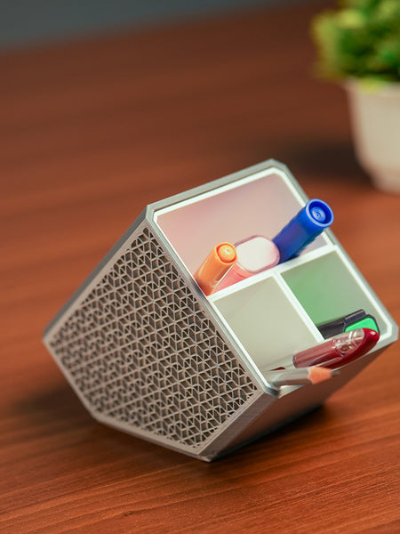 Stylish angled desk organizer with four compartments, holding colorful pens and markers, ideal for office or home workspace organization.