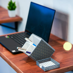Shell-shaped organizer with stationery items on a wooden surface