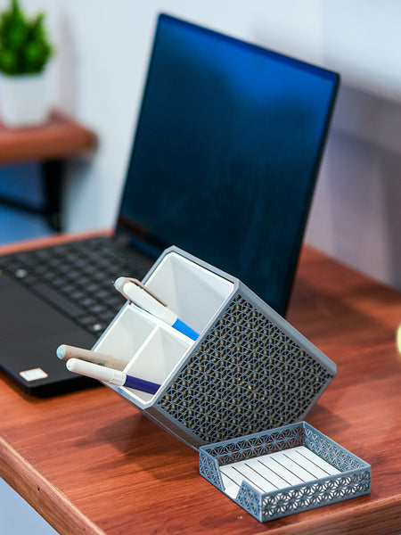 Shell-shaped organizer with stationery items on a wooden surface