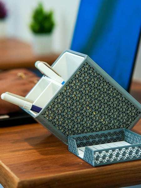 Shell-shaped organizer with stationery items on a wooden surface