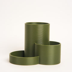 Set of green ribbed planters on a white background