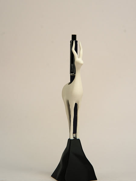 Decorative sculpture of a woman with a black base on a beige background