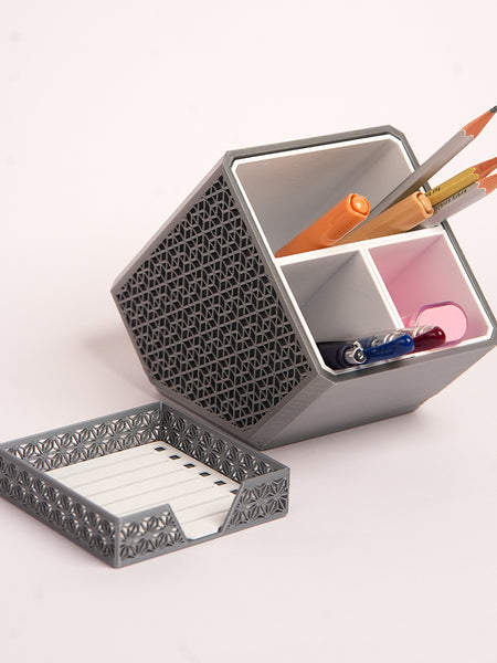 Stylish angled desk organizer with four compartments, holding colorful pens and markers, ideal for office or home workspace organization.