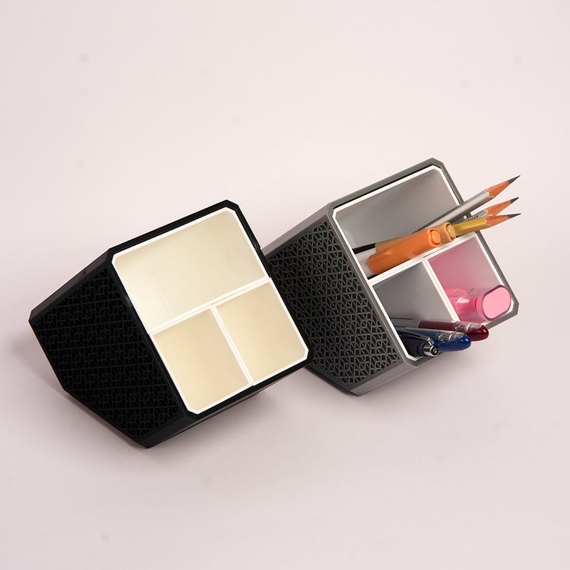 Stylish angled desk organizer with four compartments, holding colorful pens and markers, ideal for office or home workspace organization.