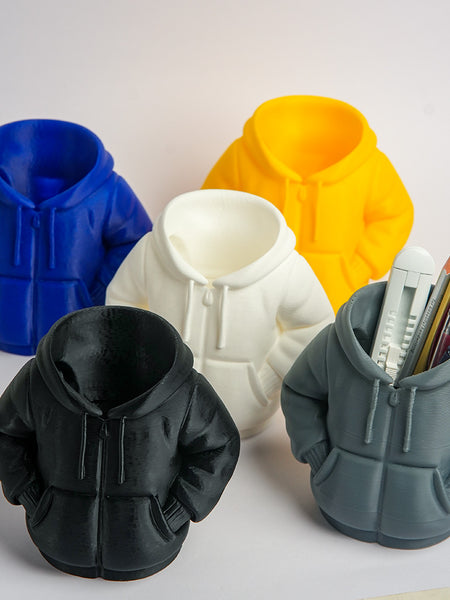 Five silicone hoodie-shaped molds in different colors with a gray mold containing pens.