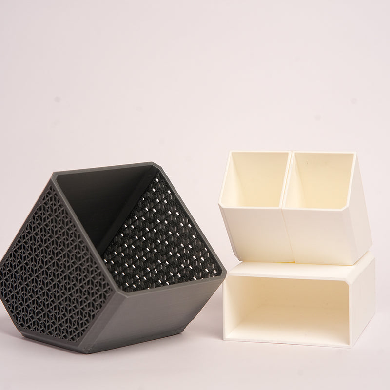 Stylish angled desk organizer with four compartments, holding colorful pens and markers, ideal for office or home workspace organization.