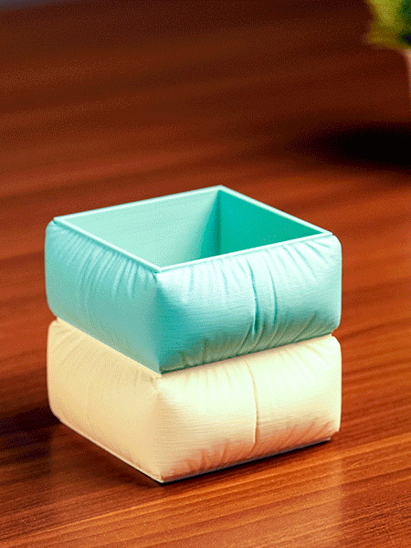 Set of colorful square-shaped pencil holders with pens on a light background in Sofa shape
